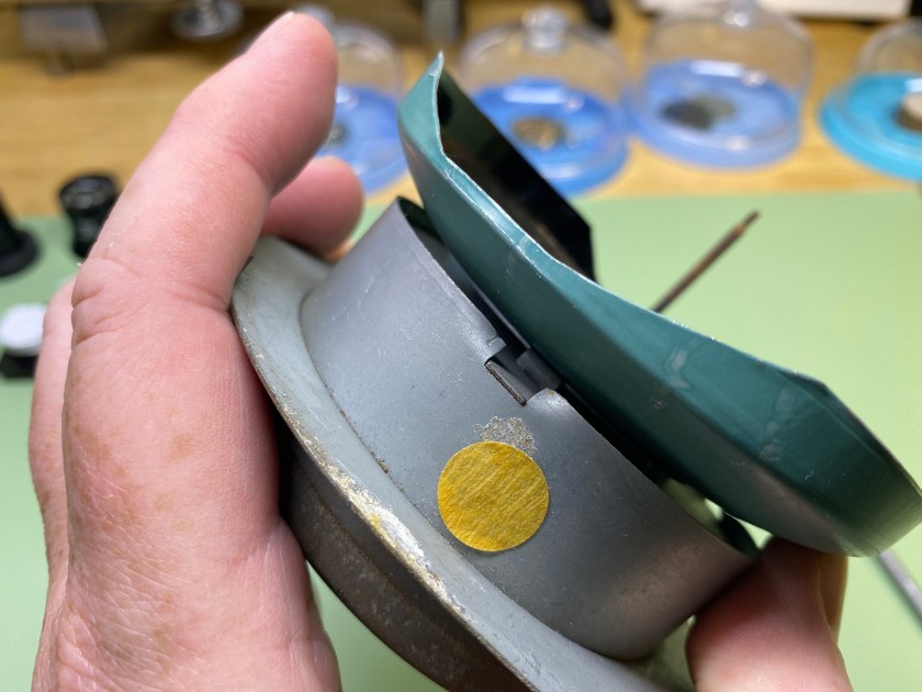 Close-up of tab connecting clock face to housing